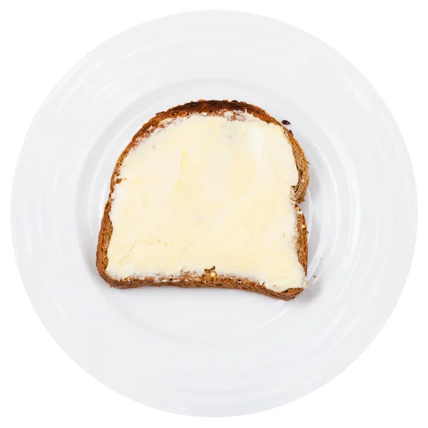 Pan de grano y sándwich de mantequilla en plato blanco — Foto de Stock