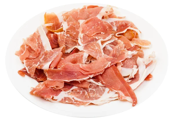 Tunt skivad torr cured ham på vit platta isolerade — Stockfoto