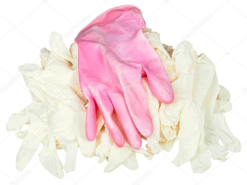 one used pink glove on pile of new medical gloves