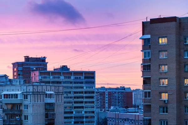Blue and pink sunset sky over city in winter — Stock Photo, Image