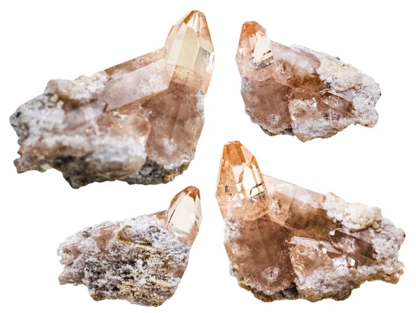 Four topaz crystals on rocks isolated on white — Stock Photo, Image