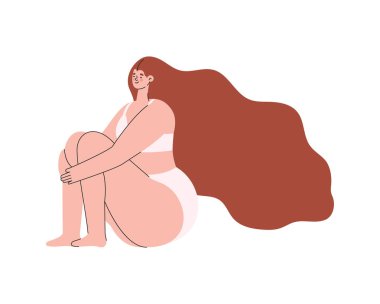 İç çamaşırlı, kızıl saçlı ve oturan bir kadın.