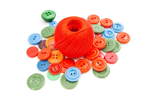 Ball of thread and colored buttons — Stock Photo, Image