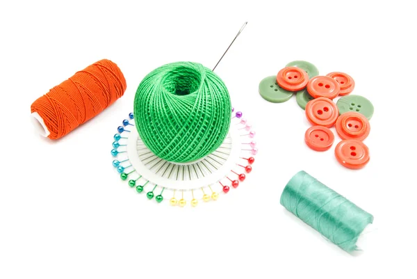 Grön och röd tråd, pins och plast knappar — Stockfoto
