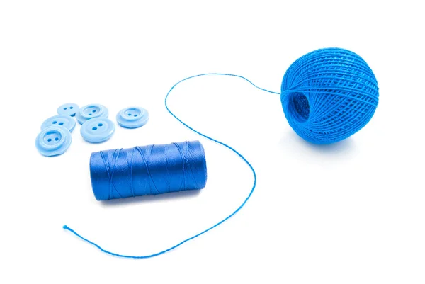 Blue spools of thread and buttons on white — Stock Photo, Image