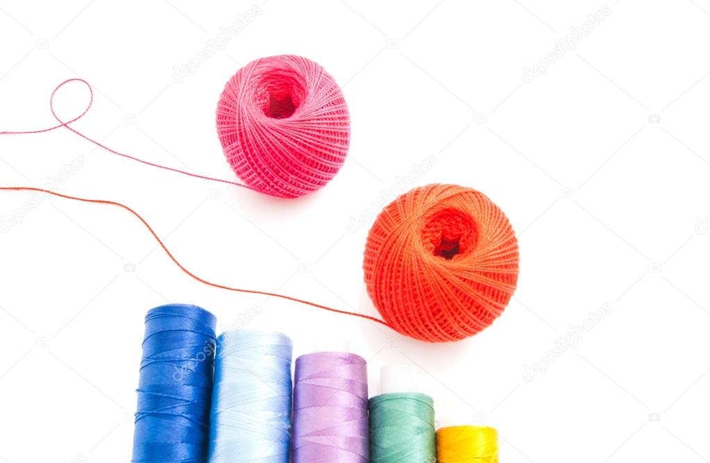two balls of yarn and threads on white