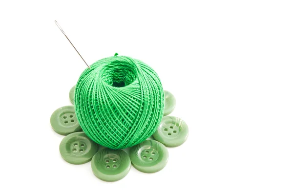 Needle, green plastic buttons and thread — Stock Photo, Image