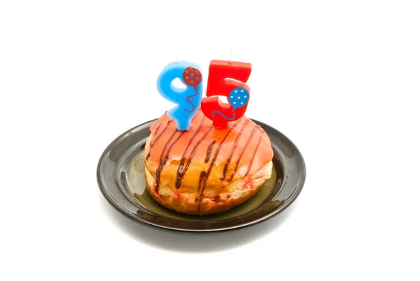 Donut with ninety five years birthday candle — Stock Photo, Image