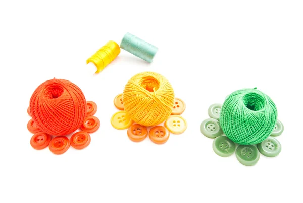 Three balls of yarn and colored buttons — Stock Photo, Image