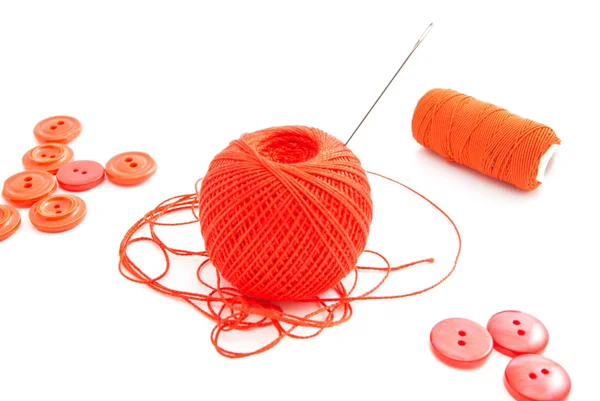 Spools of thread, needle and red buttons — Stock Photo, Image