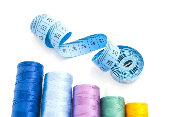 Threads and meter on white — Stock Photo, Image