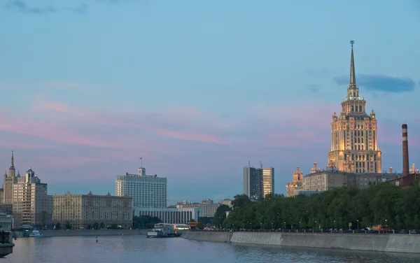 Beautiful buildings on banks of the river at sunset — Stock Photo, Image