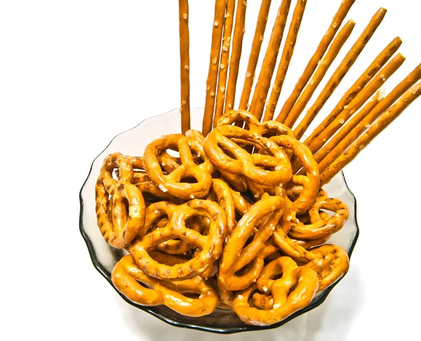 Many tasty salted pretzels and breadsticks — Stock Photo, Image