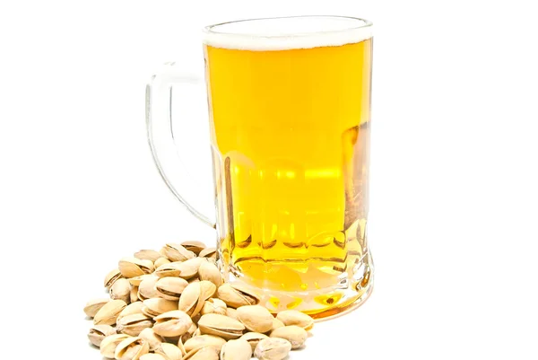 Mug of beer and pistachios on white — Stock Photo, Image