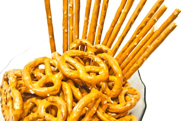 Smakelijke pretzels en breadsticks op een plaat — Stockfoto