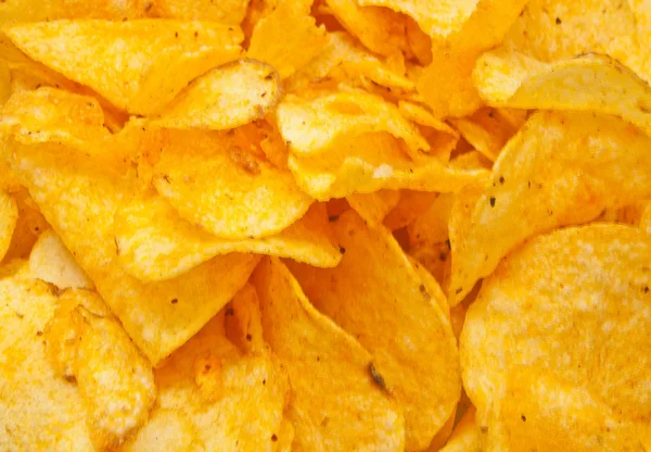 Viele leckere Kartoffelchips Nahaufnahme — Stockfoto