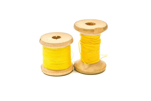 Spools of yellow thread on white — Stock Photo, Image