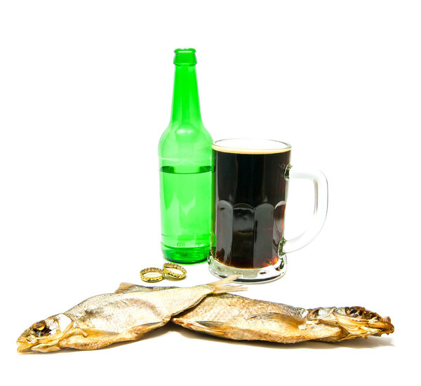 glass of beer and salted fishes on white