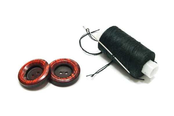 Spool of black thread and buttons — Stock Photo, Image