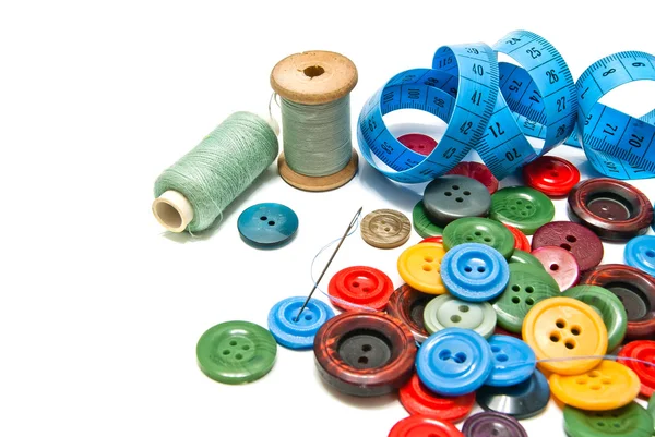 Plastic buttons and spools of thread — Stock Photo, Image