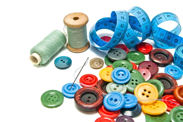 Buttons and spools of thread — Stock Photo, Image