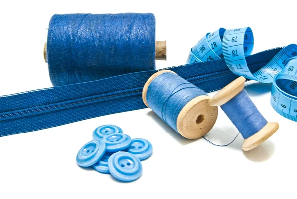 Buttons, zipper and spools of blue thread — Stock Photo, Image