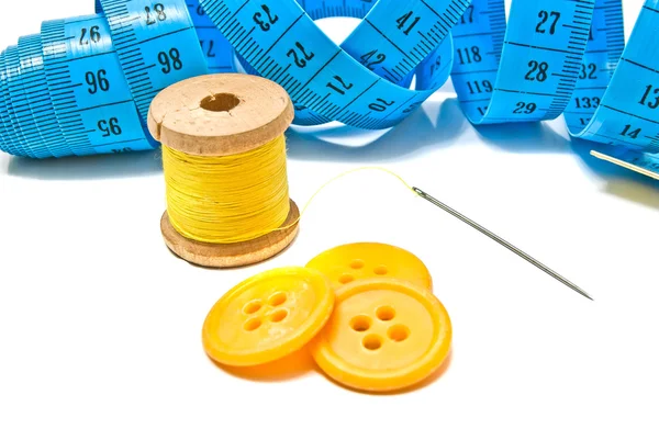 Blue meter, yellow buttons and thread — Stock Photo, Image
