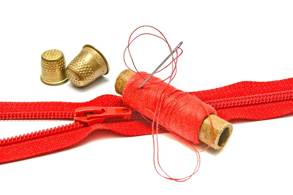 Zipper, thimble and spool of thread — Stock Photo, Image
