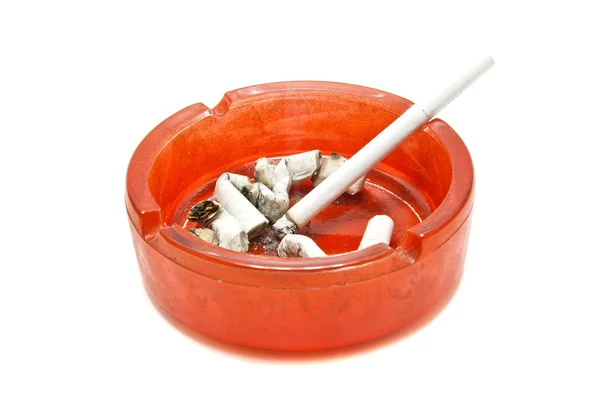 Butts and cigarette in red ashtray — Stock Photo, Image