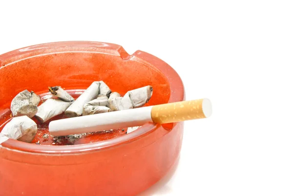 Single cigarette in red ashtray — Stock Photo, Image