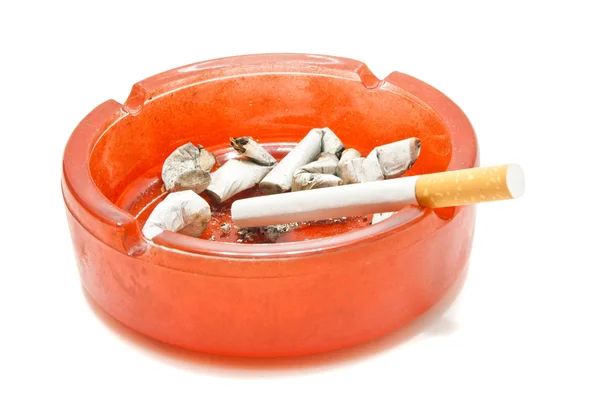 Single cigarette in red glass ashtray — Stock Photo, Image