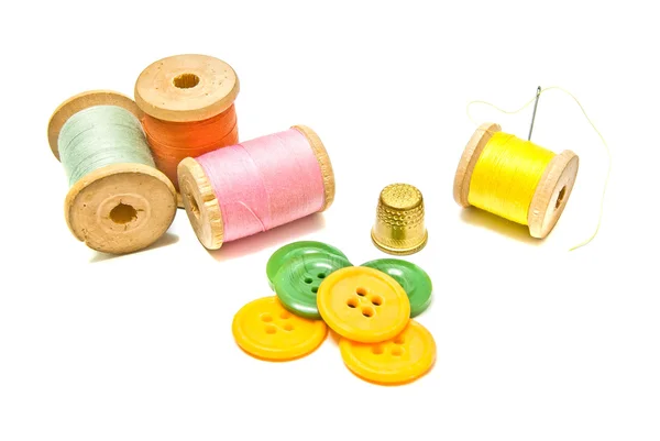 Spools of thread with buttons on white — Stock Photo, Image