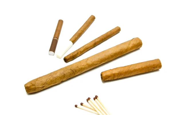 Different cigars and cigarillos with matches — Stock Photo, Image