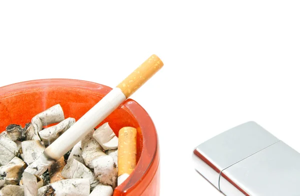 Cigarette in ashtray and metal lighter — Stock Photo, Image