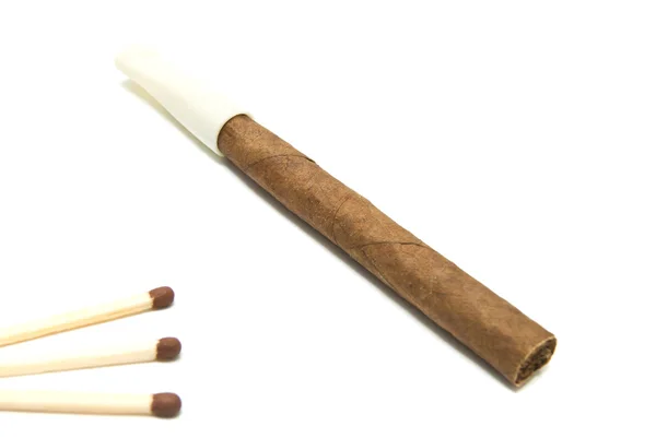 Cigarillo and three matches — Stock Photo, Image