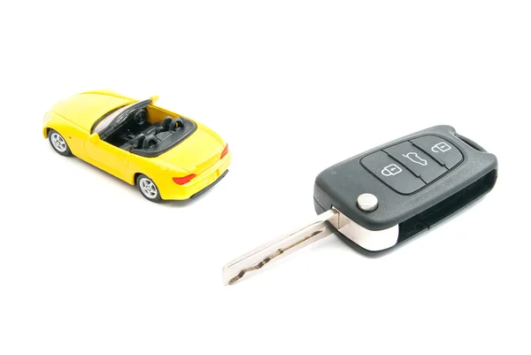Keys and yellow sport car on white — Stock Photo, Image