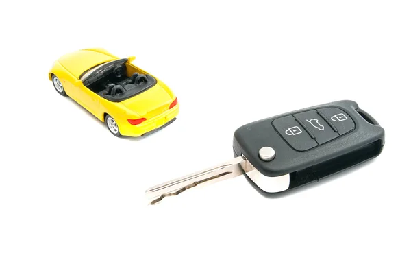 Keys and yellow car on white — Stock Photo, Image