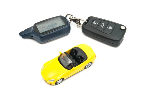 Yellow car and keys on white — Stock Photo, Image