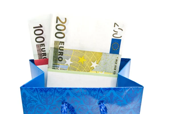 Blue gift bag with banknotes on white — Stock Photo, Image