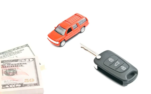 Ключи, банкноты и красный автомобиль — стоковое фото