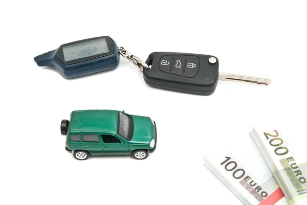 Green car, keys and notes on white — Stock Photo, Image