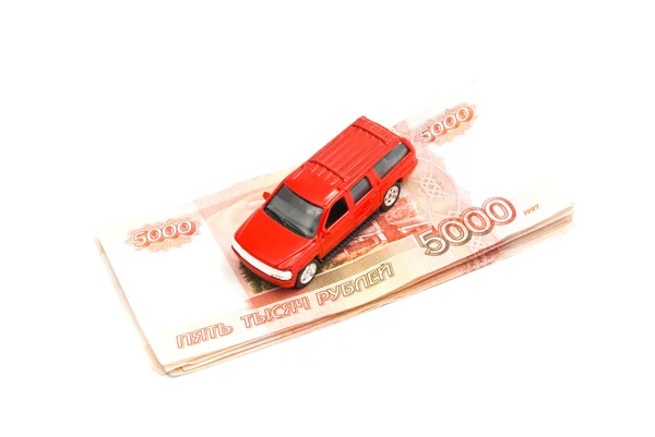 Красный автомобиль и российские банкноты — стоковое фото