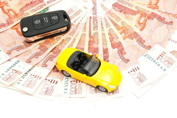 Yellow car, keys and money on white — Stock Photo, Image