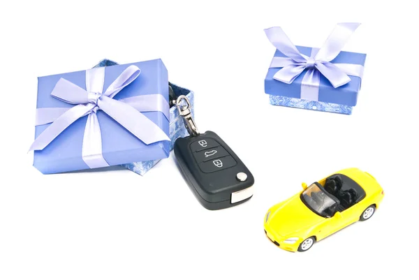 Two gift boxes, sport car and keys — Stock Photo, Image