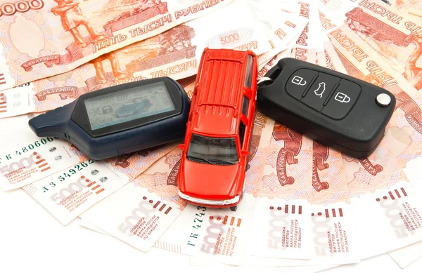 Червоний автомобіль, ключі і банкноти Стокове Зображення
