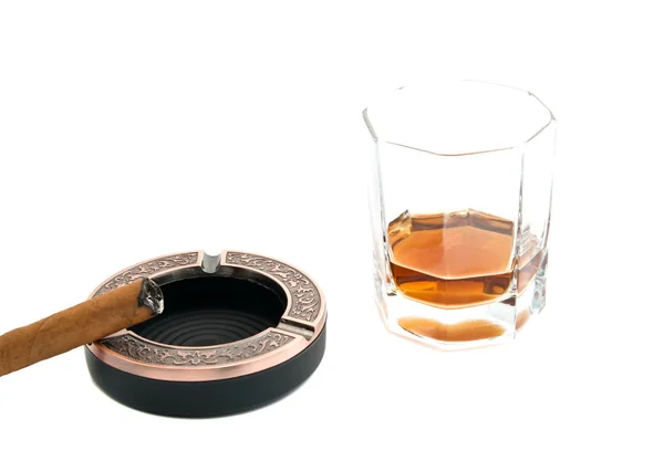 Cigar in ashtray and glass of cognac — Stock Photo, Image