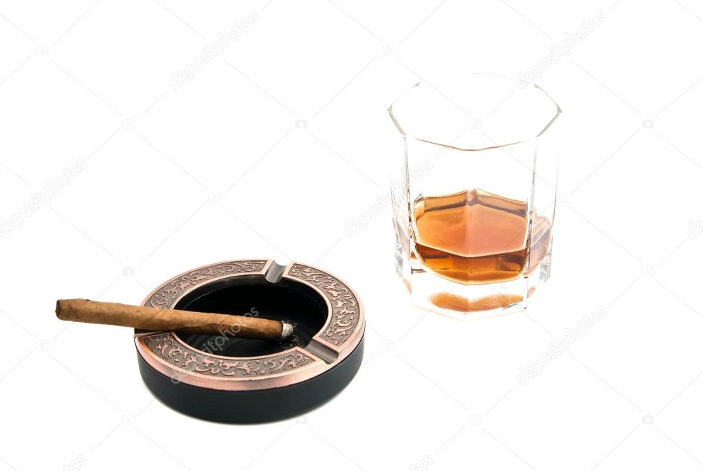 cigarillo in ashtray and whiskey 