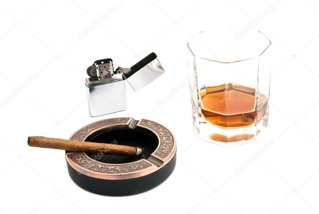 Cigarillo in ashtray and alcohol