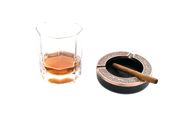 Cigarillo in ashtray and cognac on white — Stock Photo, Image
