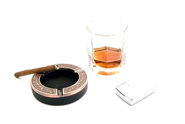 Cigarillo in ashtray, cognac and lighter — Stock Photo, Image